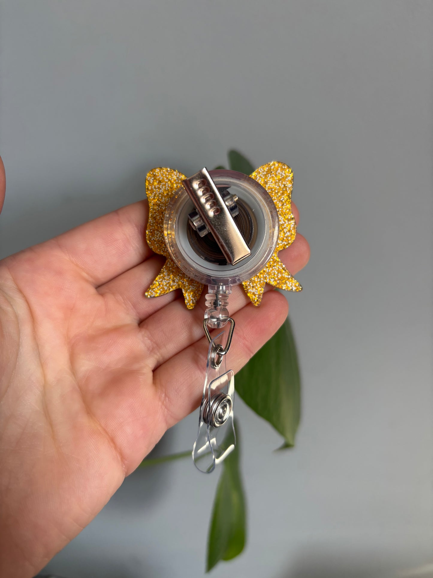 Golden leopard print retractable badge reel in a bow shape